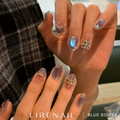 Blue Soiree press-on nails worn on both hands