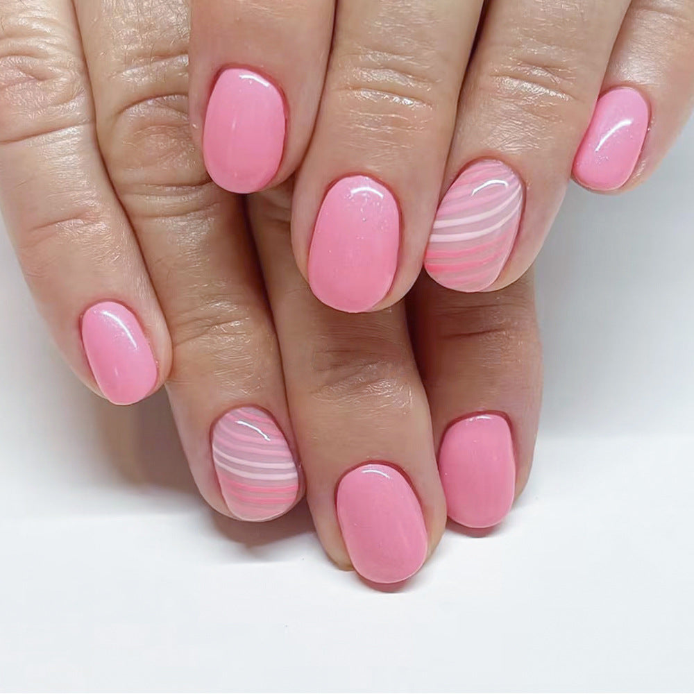 Candy Stripe Rs squoval press-on nails worn on a hand