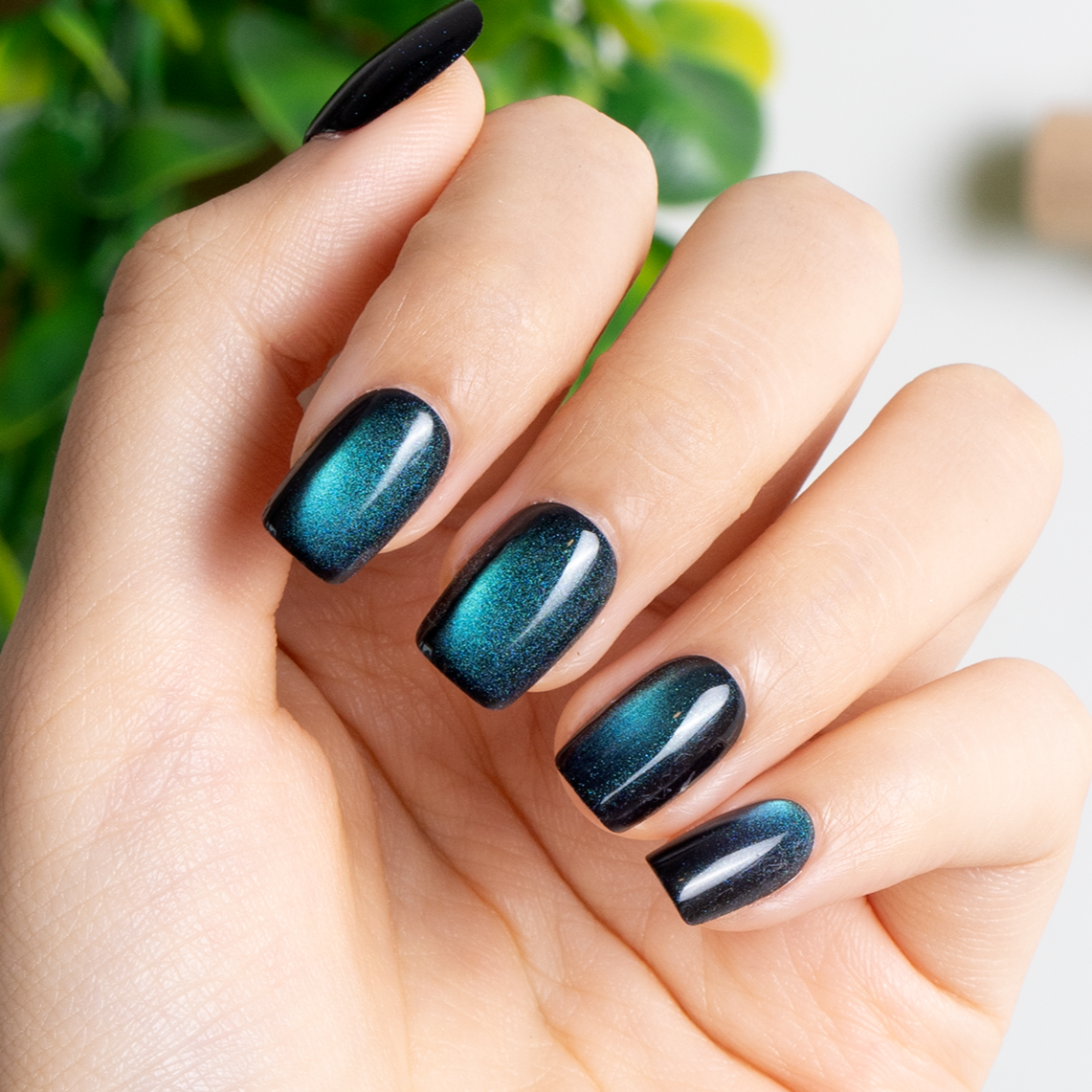 Midnight Galaxy short squoval press-on nails worn on a hand